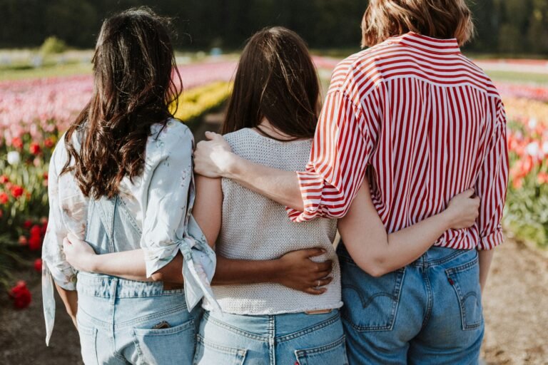 christian friends in front of a flower garden